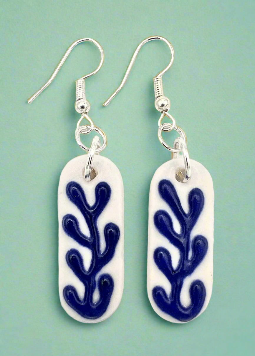 Pair of earrings with blue coral pattern on a white background